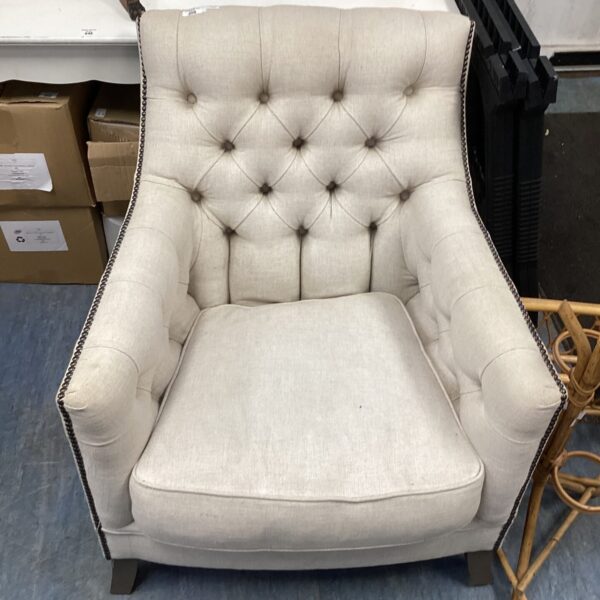 Neutral toned Trafalgar chesterfield armchair with button detailing.