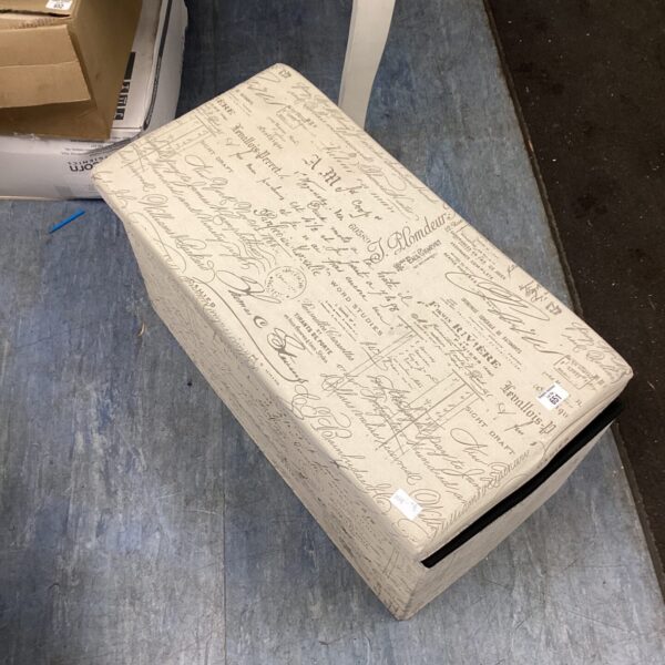 Cardboard storage box filled with a mixed lot of household items.