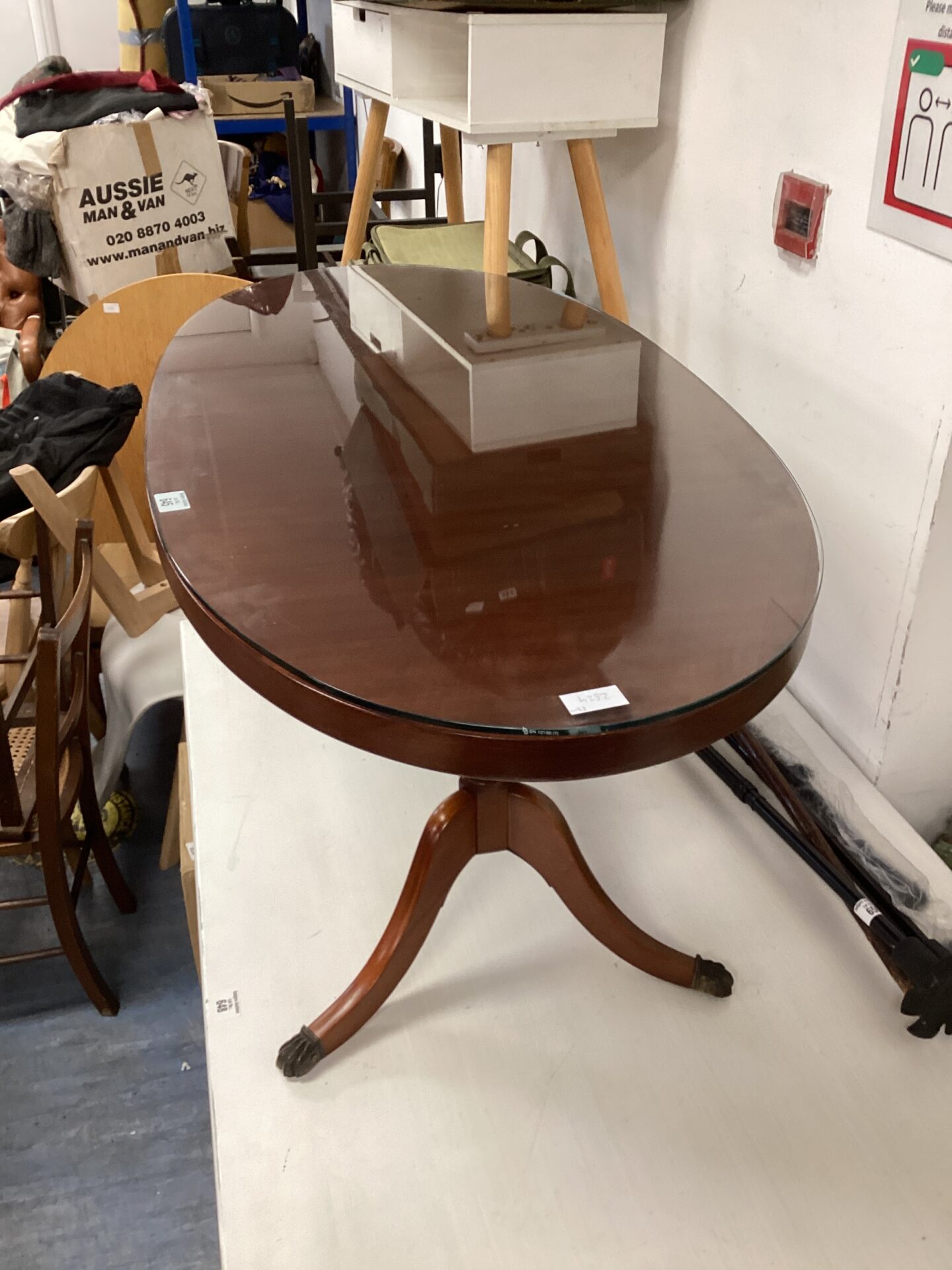 647 glass topped Claw footed oval regency style coffee table