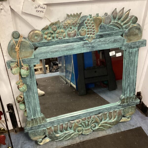 Ornate Greek style mirror with sculpted details and aged finish.