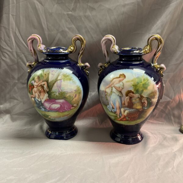 Pair of antique Vienna porcelain vases with hand-painted scenes.