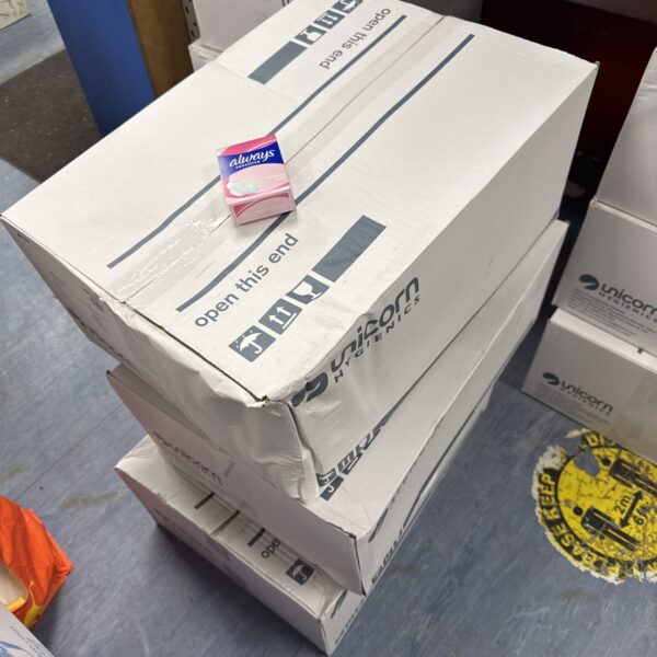 Wholesale lot of Always Sensitive sanitary towels in cardboard boxes.