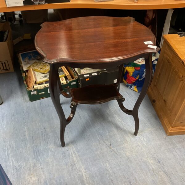 Antique mahogany lamp table with curved legs and circular top.