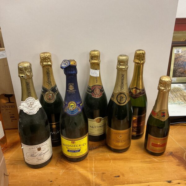Seven bottles of champagne including Heidsieck and Taittinger.