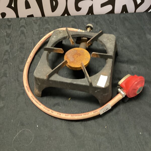 Vintage single burner camping gas stove with flexible hose.