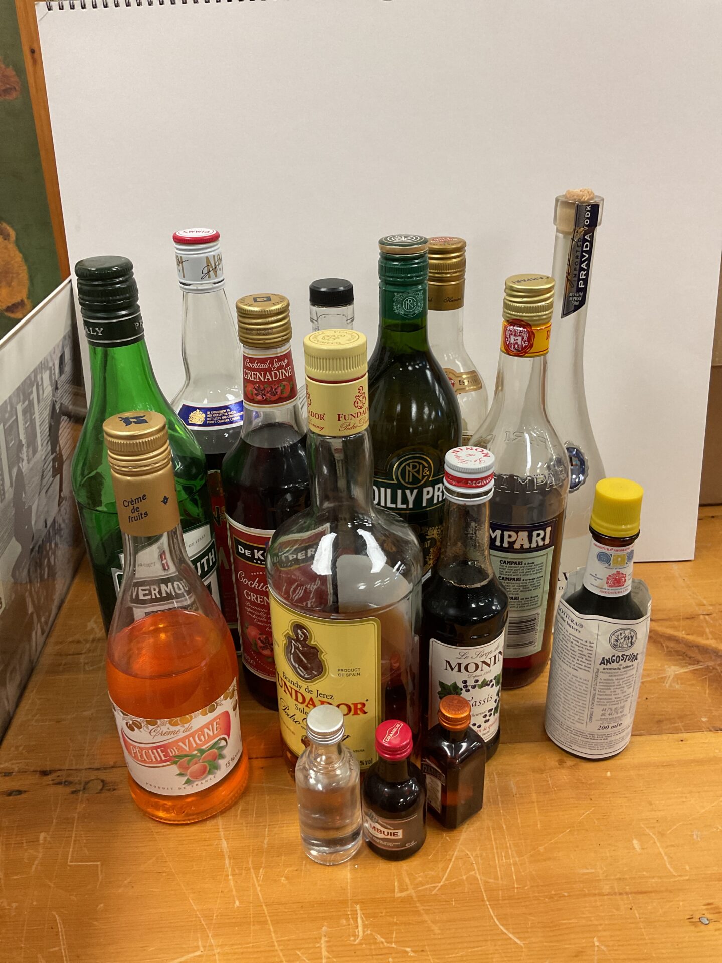749 Large lot of part drunk bottles of alcohol including pravda vodka & fundador brandy