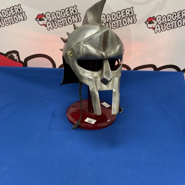 Front view of a detailed steel gladiator helmet replica.