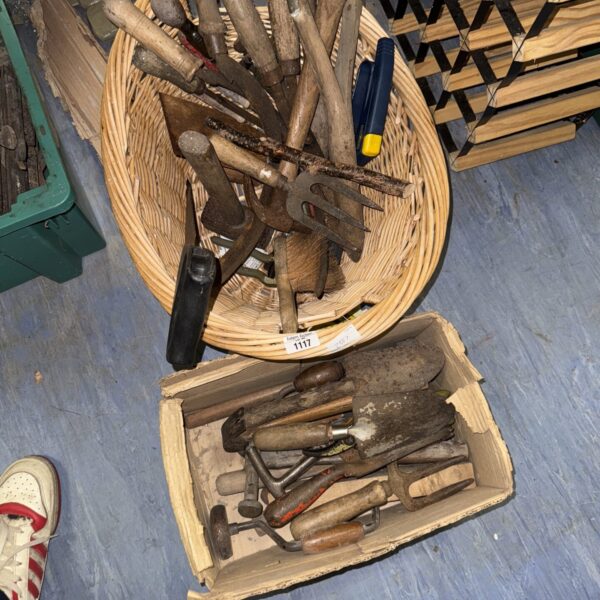 Vintage hand tools in a woven basket and plastic box.