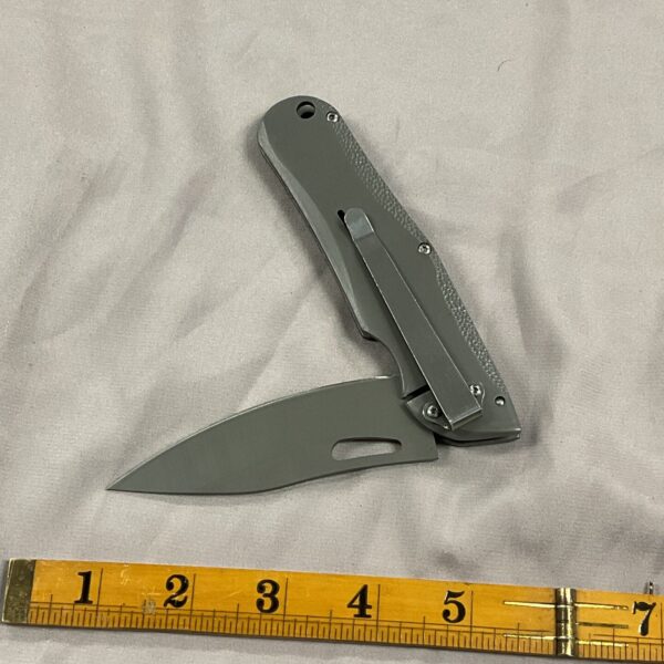 Stainless steel D2 pocket knife with belt clip for everyday carry.