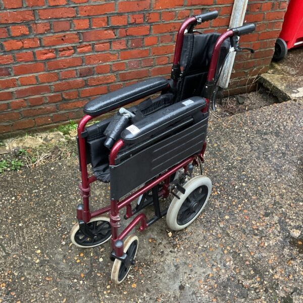 Red Z tec foldable wheelchair with black seat and wheels.