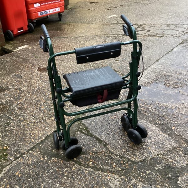 Side view of a used Uniscan mobility trolley with a padded seat.