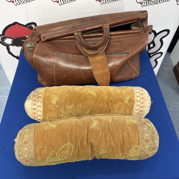 Vintage leather holdall with embroidered Middle Eastern cushions.