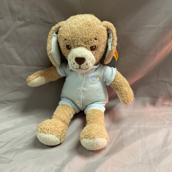 Front view of a Steiff teddy bear in a blue romper.