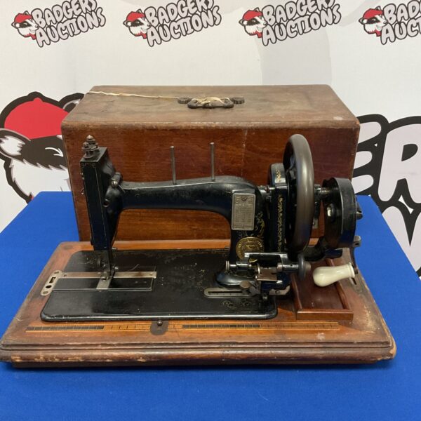 Antique Naumann hand crank sewing machine, vintage collectible.