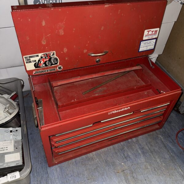 Vintage metal toolbox with multiple compartments for tool storage.