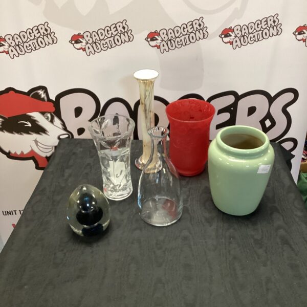 Assorted vintage glass vases and paperweight on display.