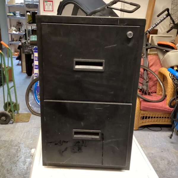 Vintage metal filing cabinet with two drawers, ideal for office storage.