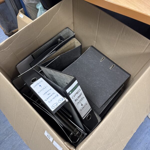 Stack of used lever arch files for document storage.