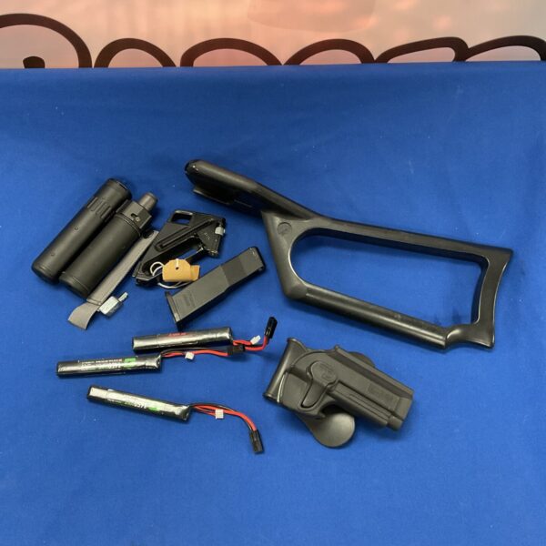 Rifle magazines, silencer, and adjustable stock for airsoft or tactical use.