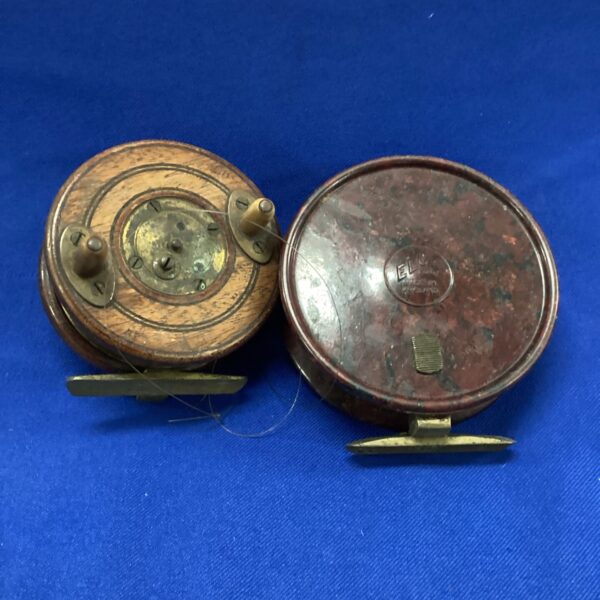 Antique fishing reel pair, bakelite and wood with brass details.