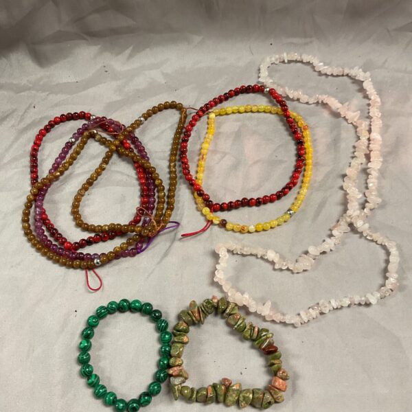 Colourful stone bracelets and necklaces in a jewellery lot.
