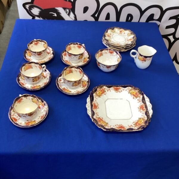 Vintage bone china tea set with floral design and gilded edges.