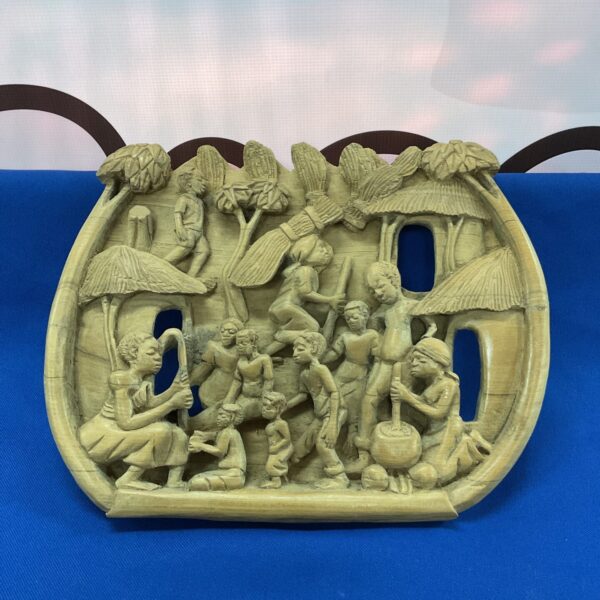Detailed African carved plaque depicting a tribal scene.