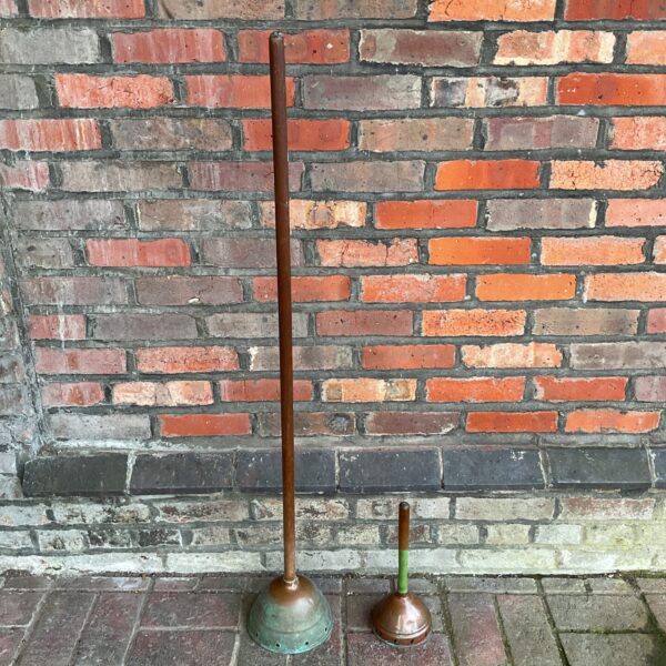Vintage copper washing dollies for hand laundry.
