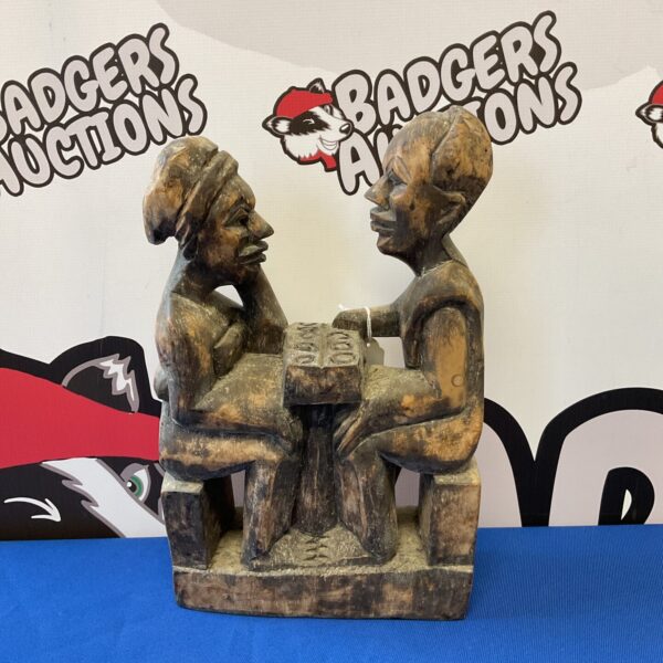 Antique carved wood figurine of game players.