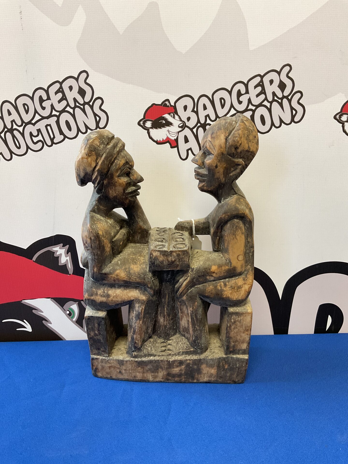027 Antique hand carved figures of man & woman playing game