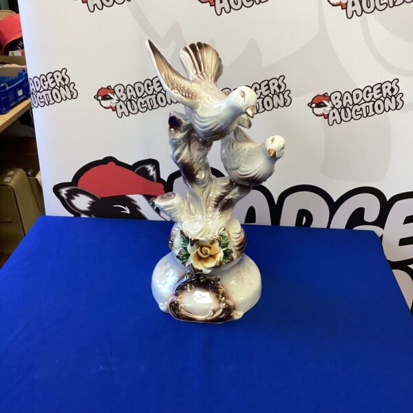 Detailed vintage Capodimonte porcelain bird figurine on display.