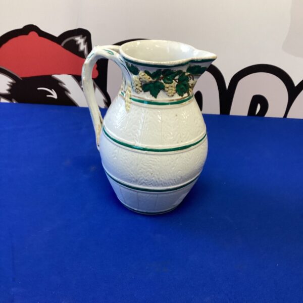 Antique Victorian porcelain jug with floral embossed detailing.