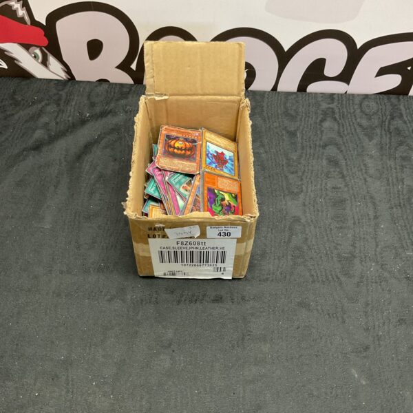 Box of assorted Yu Gi Oh trading cards for collectors.