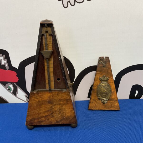 Vintage Maelzel metronome, wooden pyramid shape, antique musical instrument.