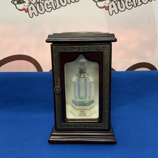 Elegant Abdul Samed Al Qurashi perfume display cabinet with glass bottles.