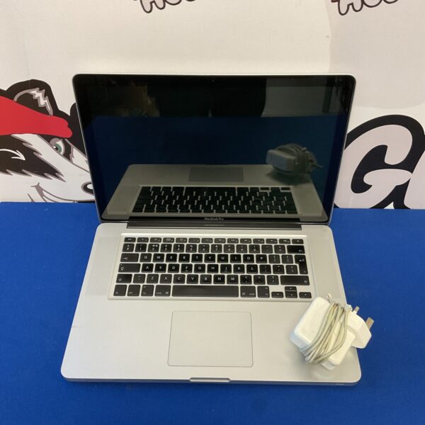 Silver Apple Macbook Pro A1286 laptop with charger.