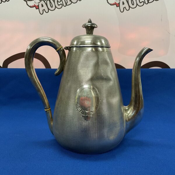 Ornate Victorian silver plated coffee pot with textured surface.