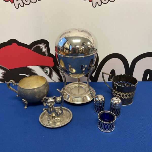 Vintage silver plate collection featuring a cat ring holder.