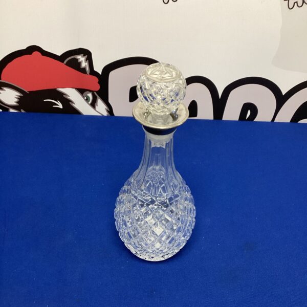 Vintage crystal decanter with silverplate stopper for liquor.