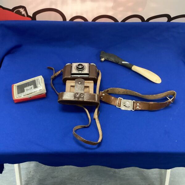 Vintage Paxina camera in leather case, classic retro photography.