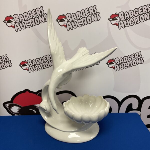 Large white Italian porcelain bird bowl for display.