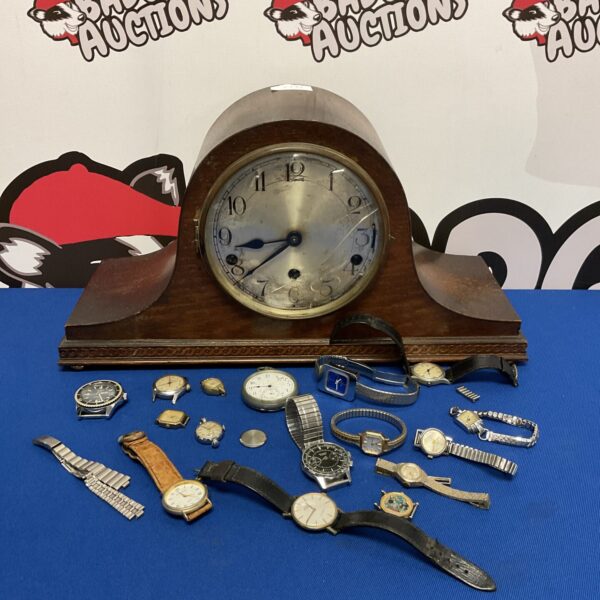 Vintage Napoleon mantle clock with a collection of watches.