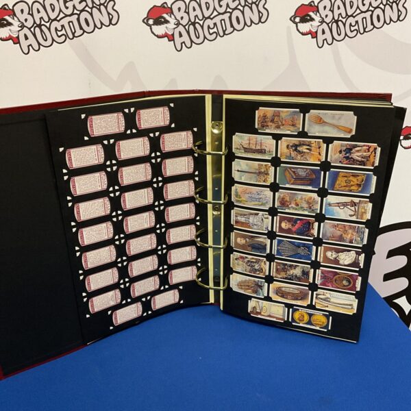 Open vintage cigarette card album with filled pages.