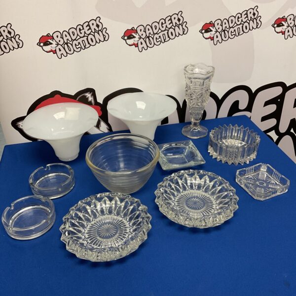 Vintage cut glass ashtrays and dishes displayed on a dark surface.