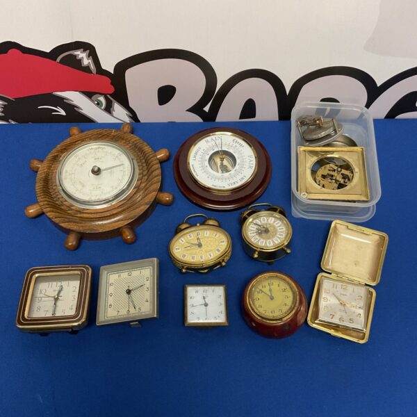 Vintage brass travel barometer showing weather conditions.