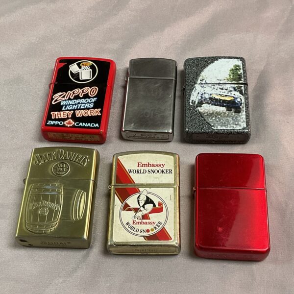 Vintage lighter lot including Zippo examples, collectible designs.