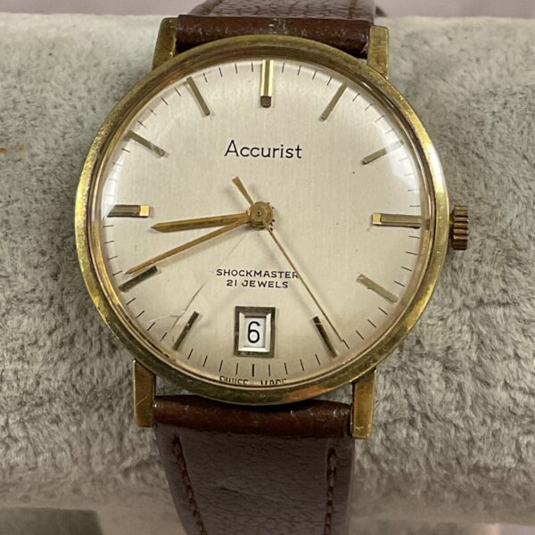 Vintage Accurist wristwatch with gold case and analogue display.
