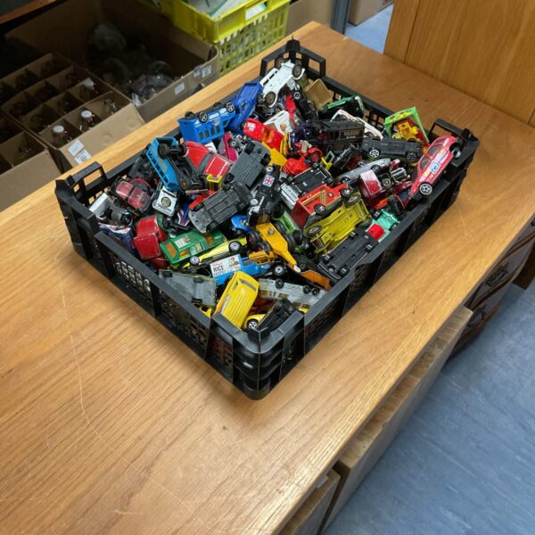 Crate filled with a large lot of vintage and modern diecast toy cars.