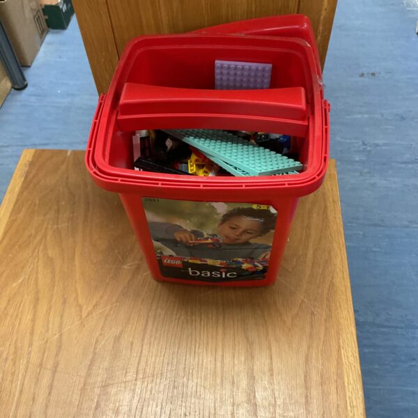 Colourful mixed Lego lot in a plastic storage box.