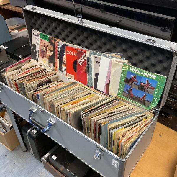 Vintage 7” vinyl records in aluminium flight case, 1980s collection.